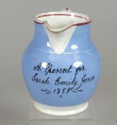 A LLANELLY POTTERY JUG 'A PRESENT FOR SARAH EMILY JONES 1885' with blue ground and red trim, 11cms