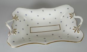 A SWANSEA PORCELAIN TWIG-HANDLED DISH of shaped rectangular form and decorated in the cornflower