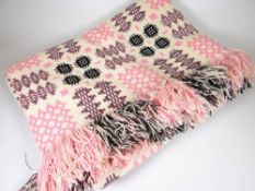 TRADITIONAL WELSH WOOL BLANKET of cream ground and having pink, purple and black geometric patterns,