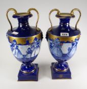 A pair of Continental twin-handled pottery pedestal vases decorated with Dutch figures Condition