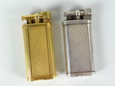Two Dunhill gas cigarette lighters with white metal and yellow metal engine turned example Condition