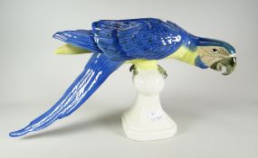 A Royal Dux pottery perched parrot model, 41cms long Condition reports provided on request by