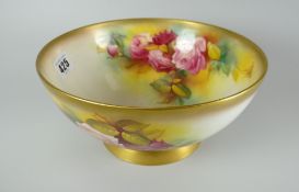 A Royal Worcester porcelain footed bowl painted with pink roses and foliage to interior and