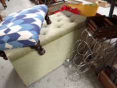 A vintage light green dralon ottoman, small footstool, large rug and wine racks together with a