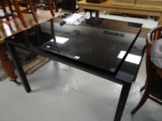 A contemporary black glass extending dining table Condition reports provided on request by email for