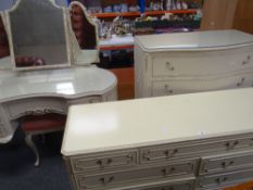 A vintage cream French-style six-piece bedroom suite comprising kidney shaped dressing table,