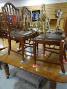 A good vintage oak dining table and four chairs, 150 x 126cms together with a brass effect eight-