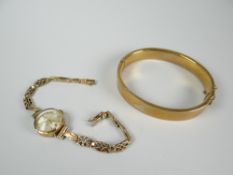An engraved 9ct gold bangle, 13gms and 9k ladies bracelet watch Condition reports provided on
