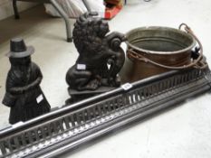 A matt black cast metal fender, three cast metal door stops, copper pot Condition reports provided