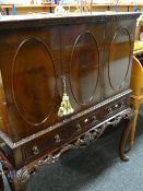 A reproduction cocktail cabinet on stand, 112cms wide x 134cms high Condition reports provided on