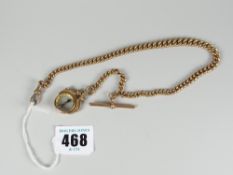 A 9ct yellow gold muff chain with t-bar and suspended compass fob in 9ct yellow gold frame, 42gms