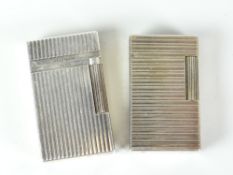 Two S T Dupont white metal gas cigarette lighters with raised rib decoration Condition reports