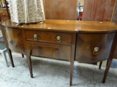 An inlaid mahogany antique breakfront sideboard having a pair of flanking curved cupboards, centre