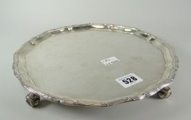 Solid silver salver raised on four scroll-type feet, London hallmarked, maker's J R C A Ltd, 21 troy