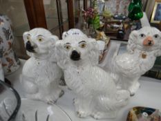 Four various seated Staffordshire pottery spaniels Condition reports provided on request by email