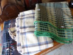 A pale green, yellow & black geometric patterned Welsh blanket, two check woollen blankets & a