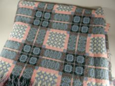 A good traditional Welsh blanket patterned in pink, powder blue and green with typical geometric
