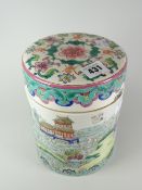 A Famille Rose cylindrical jar and cover with lid decorated in enamels with a landscape scene and
