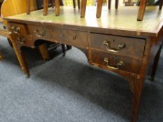 An Edwardian inlaid mahogany writing desk with tooled green leather insert-top and with a bank of