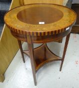 An Edwardian inlaid and painted circular top occasional table with shaped lower tier shelf on