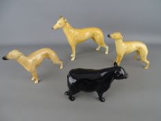 Three Beswick greyhound figurines including 'Champion Jovial Roger' and an unmarked pottery model of