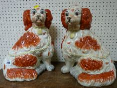 Pair of brown and white Staffs dogs with separate front legs