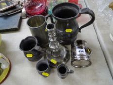 Interesting pewter candlestick and a selection of various sized tankards