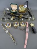 Rectangular glass tray of lady's and gent's watches, three porcelain pillboxes, a folding travel