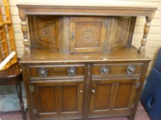 Polished buffet cupboard on turned supports and with carved upper panels