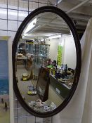 Large framed oval bevelled wall mirror, 82 x 52 cms