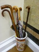 Oriental decorated stickstand and quantity of walking sticks/umbrellas