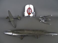 Collection of chrome plated bonnet and grill mount mascots including a stylized bird and plane, a