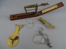 W & T Avery folding sovereign balance and one other, a folding magnifier, a clip over monocle lens