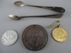 Pair of EP sugar tongs, a Welsh Sunday School bronze medal etc
