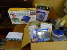 Boxed Iomega zip kit 2000, a boxed mini fan heater and a mixed box of electronics