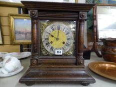 Oak cased bracket clock with Art Nouveau spandrels and silvered dial set with Roman numerals