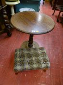 Oak circular topped pedestal table and a tapestry topped footstool