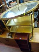 Brass effect three tier trolley, oval gilt framed bevelled edge mirror and two modern CD storage