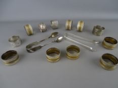 Collection of vintage napkin rings, one marked silver and two sets of silver sugar tongs including