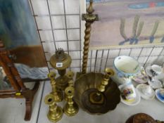 Brass oil lamp base, a selection of brass candlesticks and a bowl