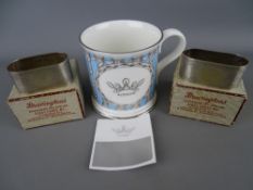 1997 commemorative mug in original box and two hallmarked silver napkin rings in Bravington's boxes