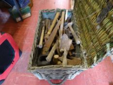 Wicker basket containing large quantity of hand tools including trowels, hammers, saws, files etc