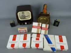 Collection of smoking memorabilia including a vintage bakelite TV cigarette box with moving view,