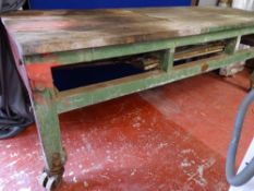 Substantial 8 x 3 ft approx workbench, no drawers on metal roller wheels, maker's name T Barker,