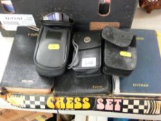 Boxed quantity of plastic chess pieces, an Hitachi digital camera and two others along with three