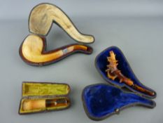 Two vintage Meerschaum and amber pipes and a cheroot holder, all cased (damages)
