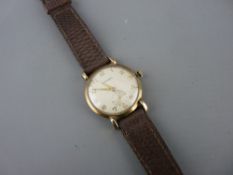 Garrard nine carat gold cased gent's wristwatch with subsidiary seconds dial on a leather strap, the