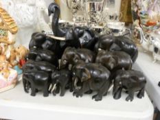 Two sets of carved ebony graduated elephant ornaments