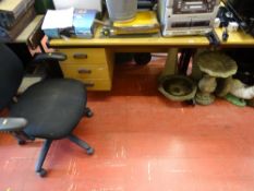 Substantial light wood office desk with three drawers, a similar desk and a black upholstered office