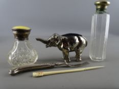 Guilloche enamel and silver topped scent bottle with one other, a white metal elephant pin cushion